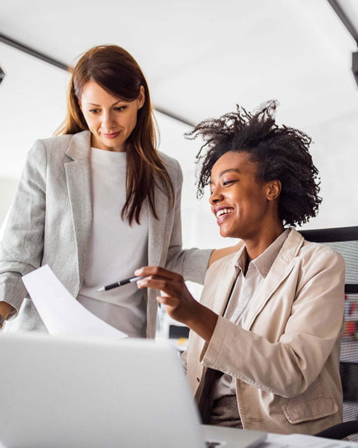 Female Real estate agent and client reviewing paper contract